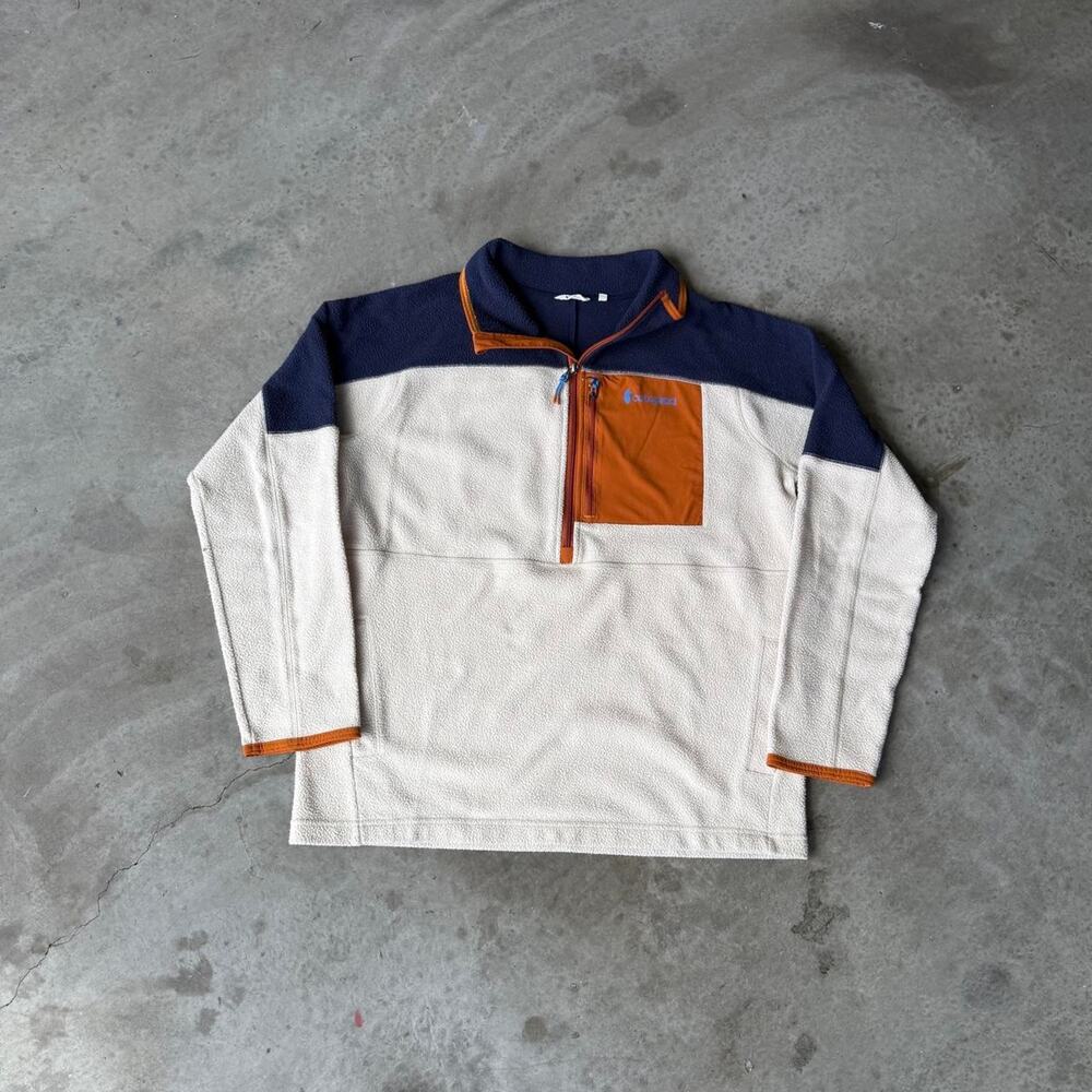 Cotopaxi Abraza 1/2 Zip Fleece Jacket Navy Blue, Cream and Orange Color Blocking